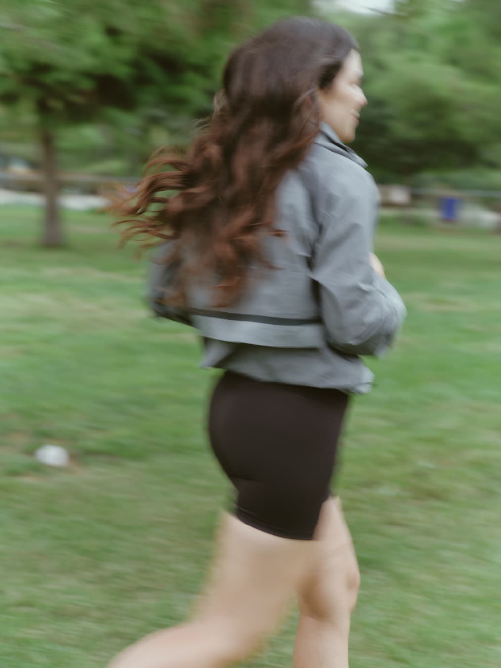 Guada running in a park, her hair in motion